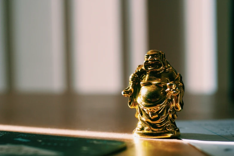 a golden statue sitting next to an ipod