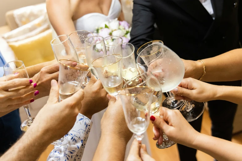 there are many people holding champagne glasses together