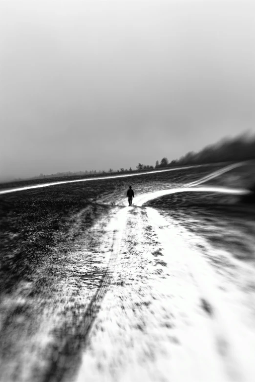 a man in black walking down a path