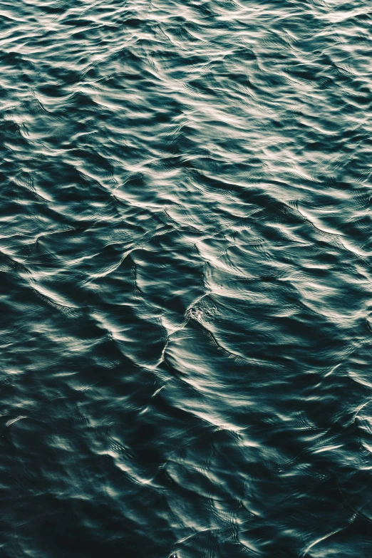 the dark water of an ocean with small waves