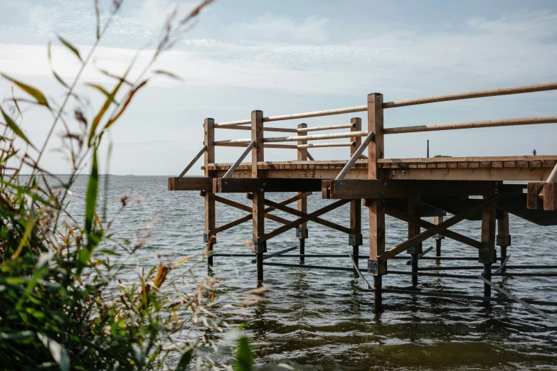 an overpass with a fence that extends into the water