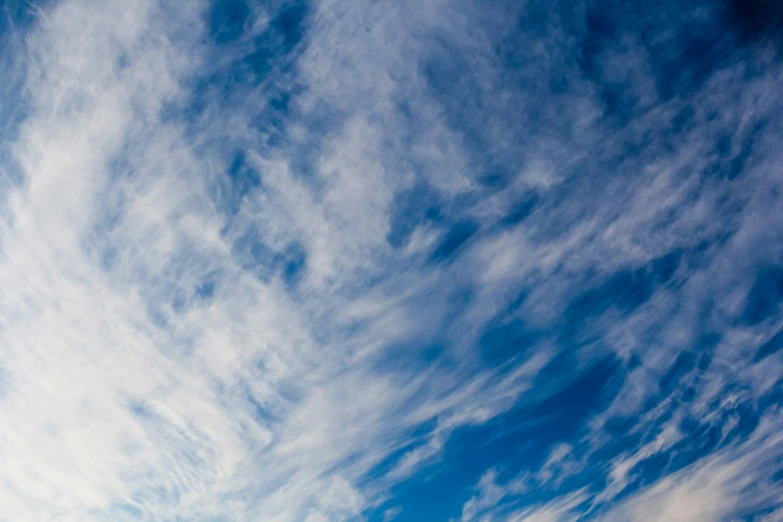 a plane flying in the air while covered with clouds