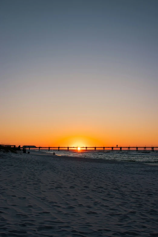 a sunset with the sun going down over the ocean