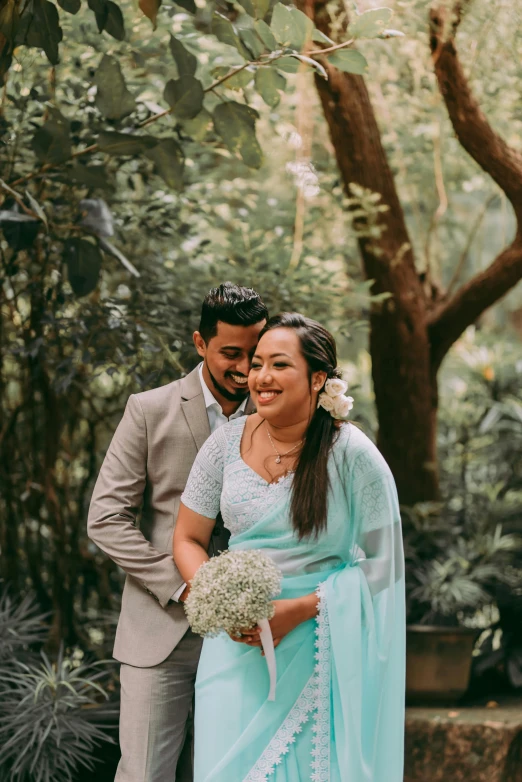 a beautiful young couple standing in the woods