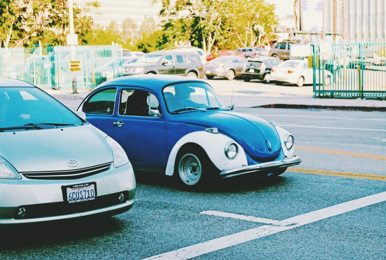 two cars that are parked in the street