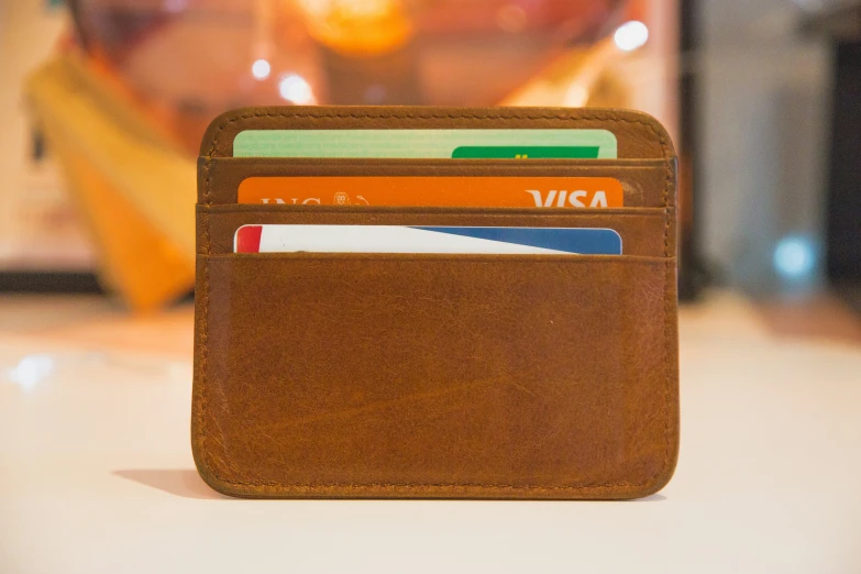 a wallet with three cards sticking out of it