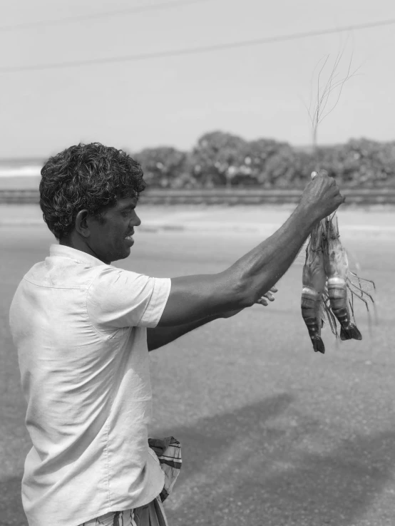 a man that is holding some kind of fish