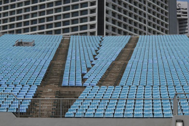 the building's roof is covered with blue seats