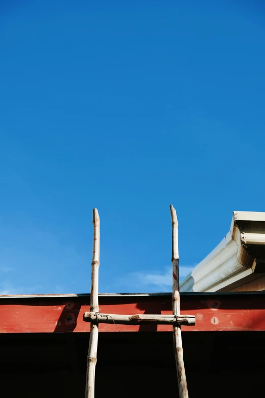 two large wooden windows on top of a roof