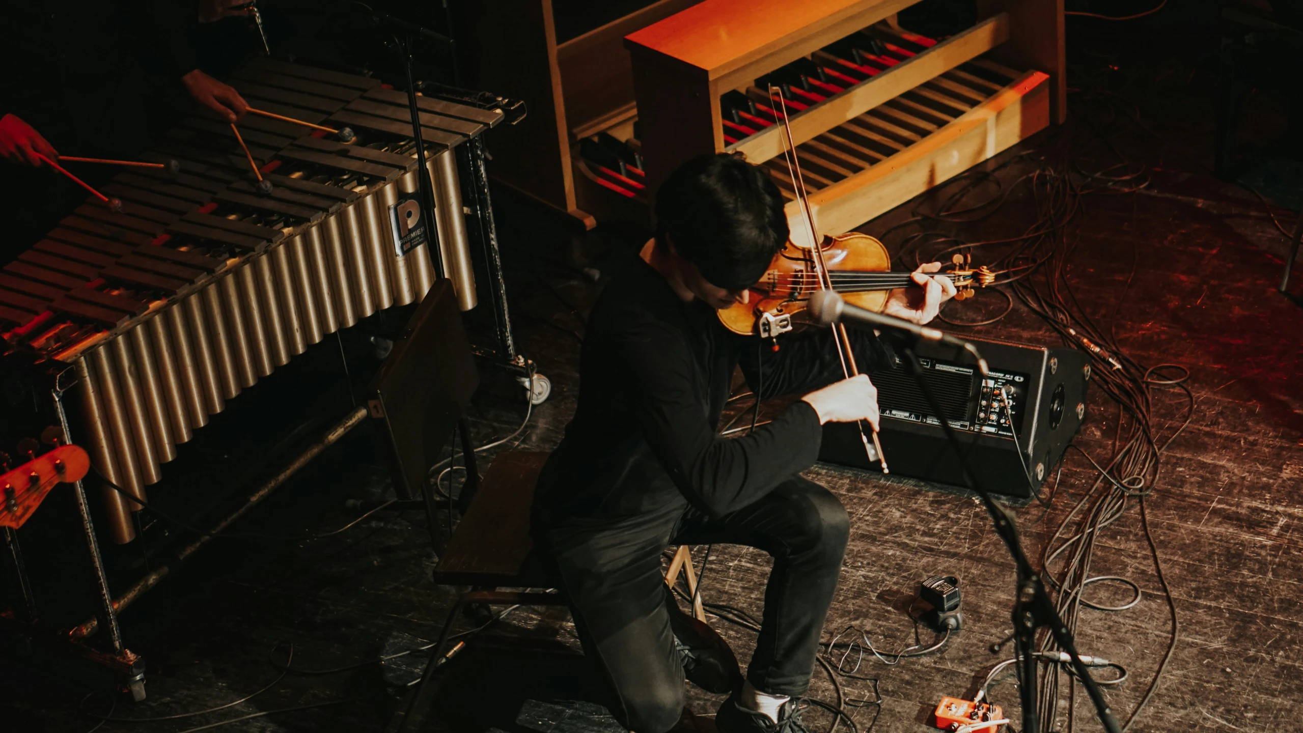 a man sitting in a chair playing an acoustic guitar