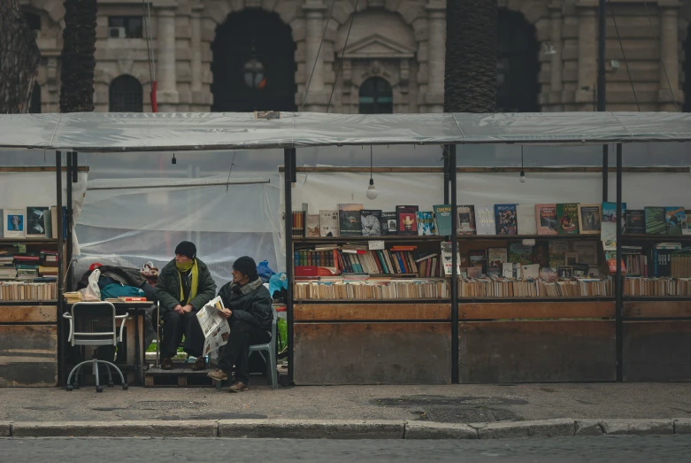 two people stand in the back of a small store