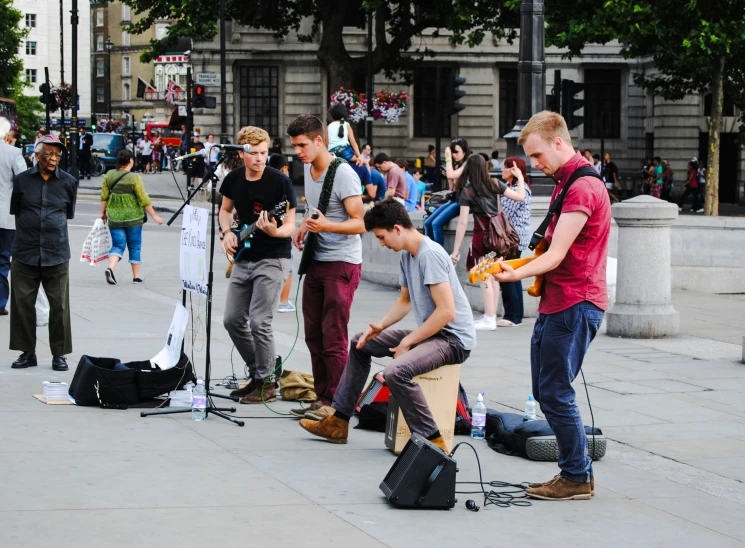 people in the street playing music in the city