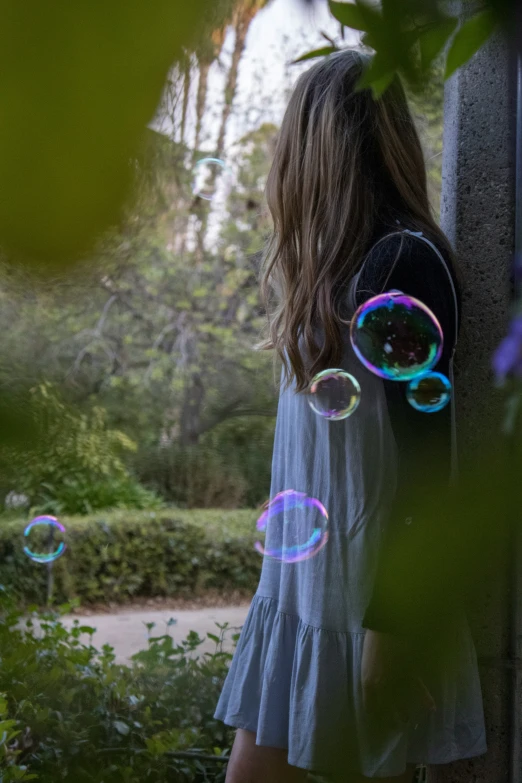 girl with bubbles in front of her, while she walks