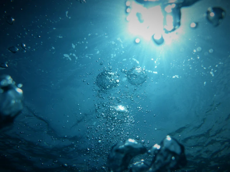 the sun is visible over a body of water