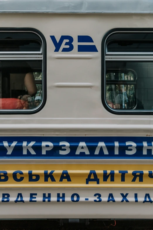 a white and blue bus with red seats