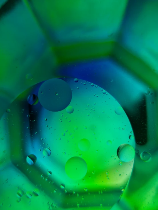 an abstract image of water droplets on top of a green flower