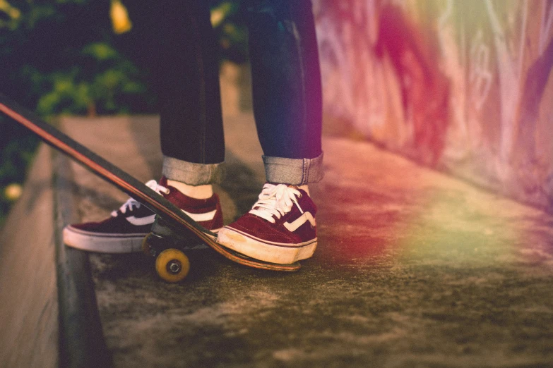 someone wearing a red and white shoe with a skateboard