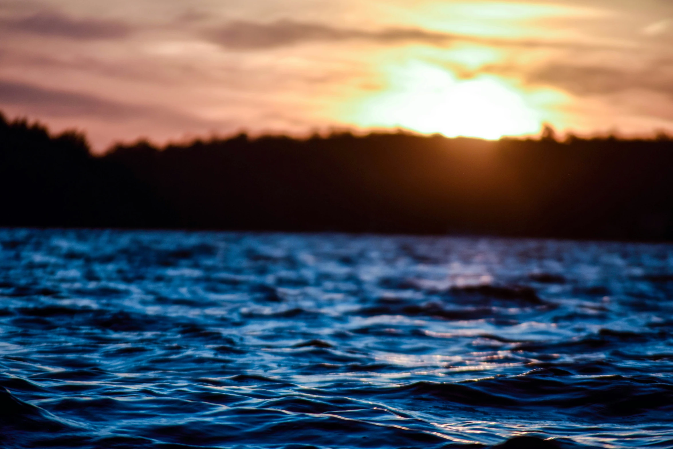 a sunset in the middle of the ocean