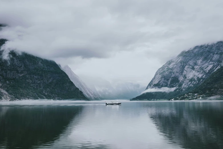 a boat on a lake in the mountains