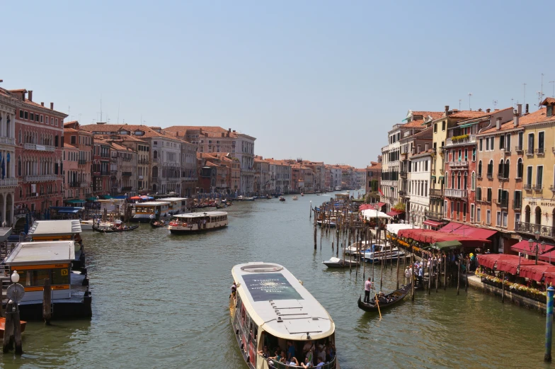 a boat traveling down the river between some buildings