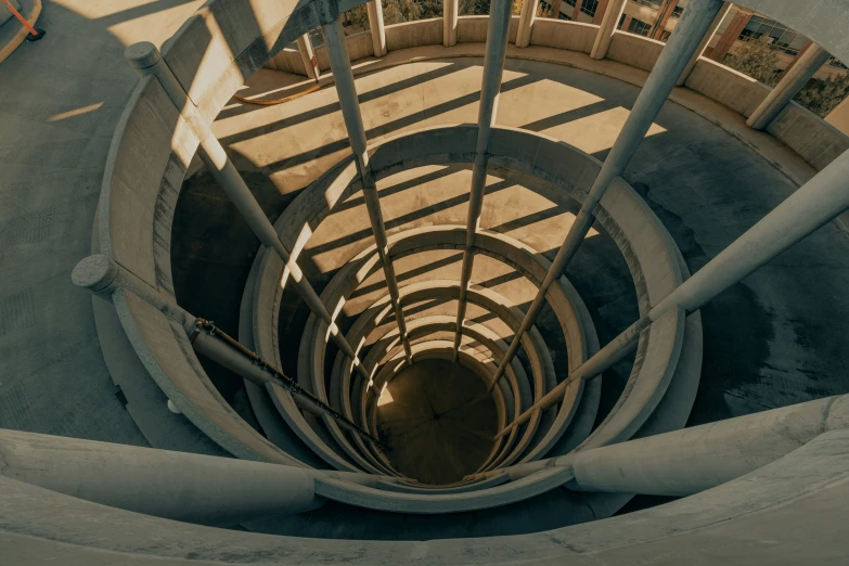 a spiral staircase with a person walking in it