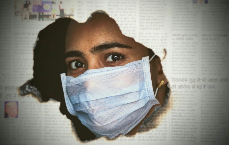 a woman wears a surgical mask to protect herself from the sun