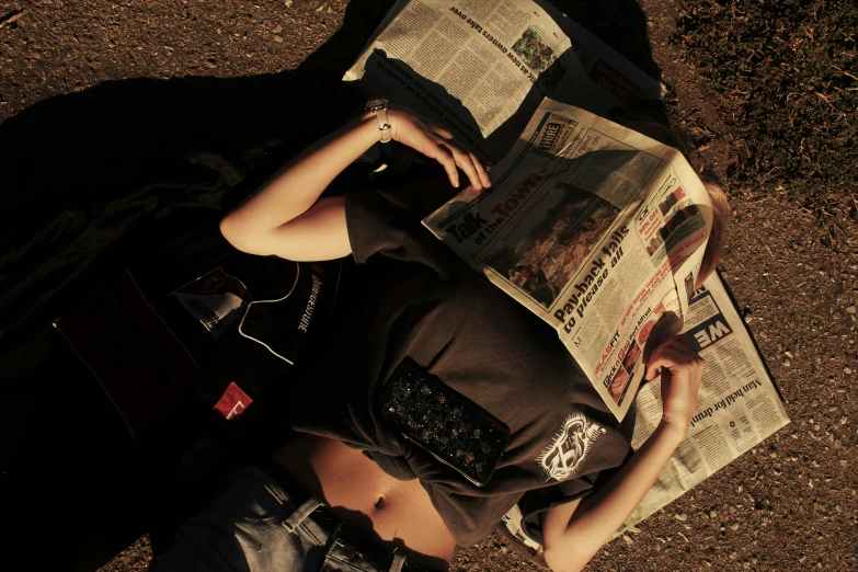 a man sitting down reading a newspaper