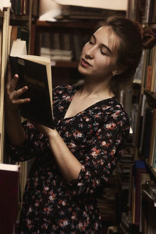 a young woman is reading in a liry