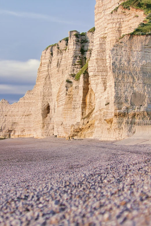 the shoreline is covered with small rocks and sand