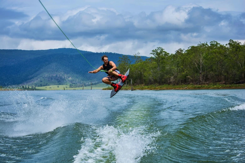 a man that is riding a wake board in the water