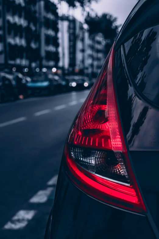 a black car is parked on a dark road