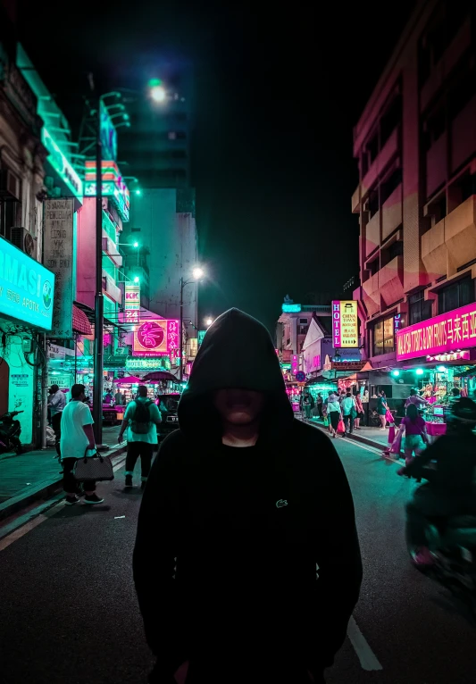 a person with dark clothes in the middle of the street