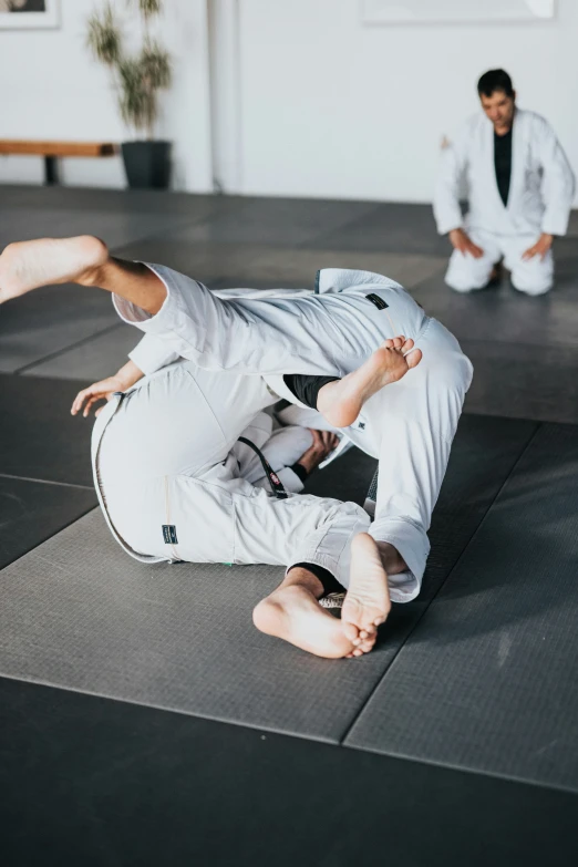 a person is doing an inverted sweep on the floor