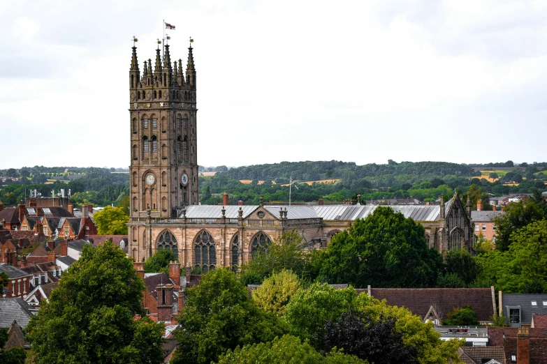 the church tower stands high over a city