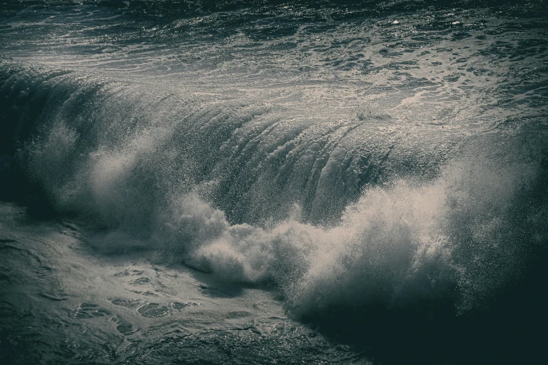 water gushing from a crashing wave into a beach