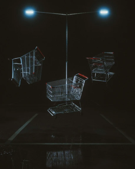 three empty shopping carts sitting in the dark