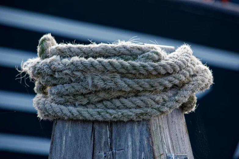 a wood pole with some kind of woven rope