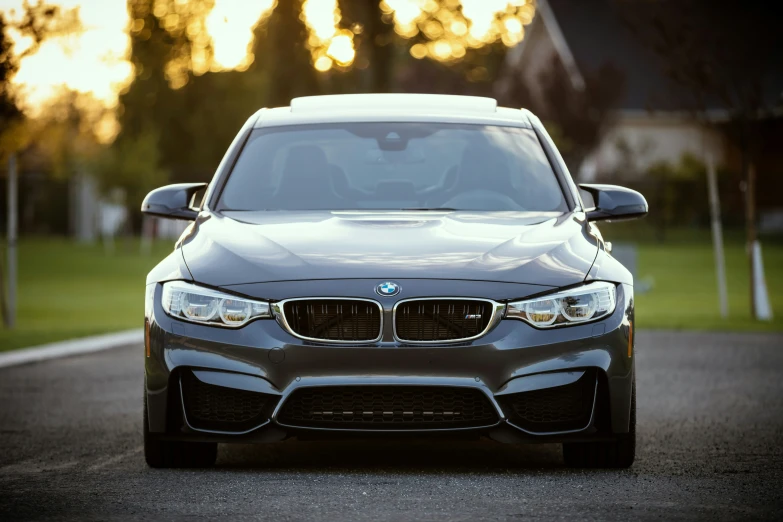 the front view of a grey bmw car with a license plate