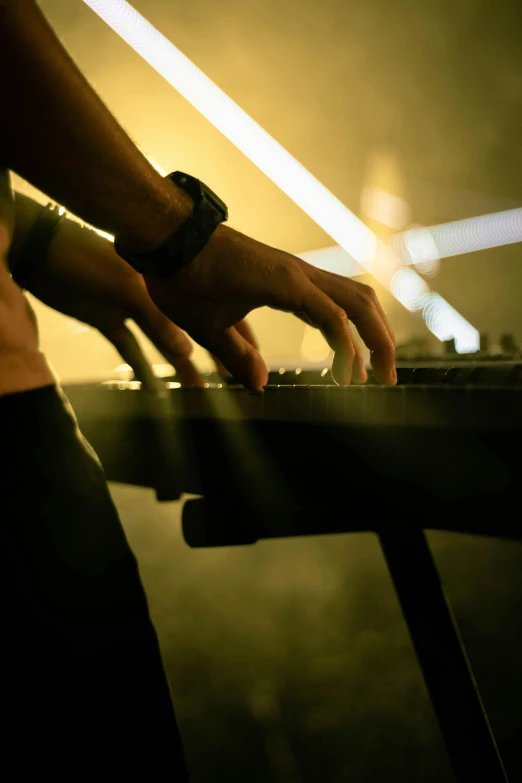 a person playing an electronic instrument with their hands