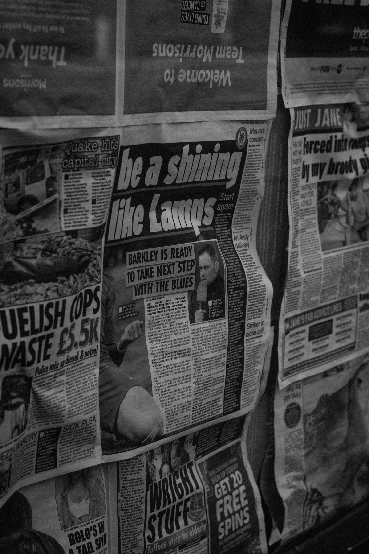 newspapers stacked on top of each other on display