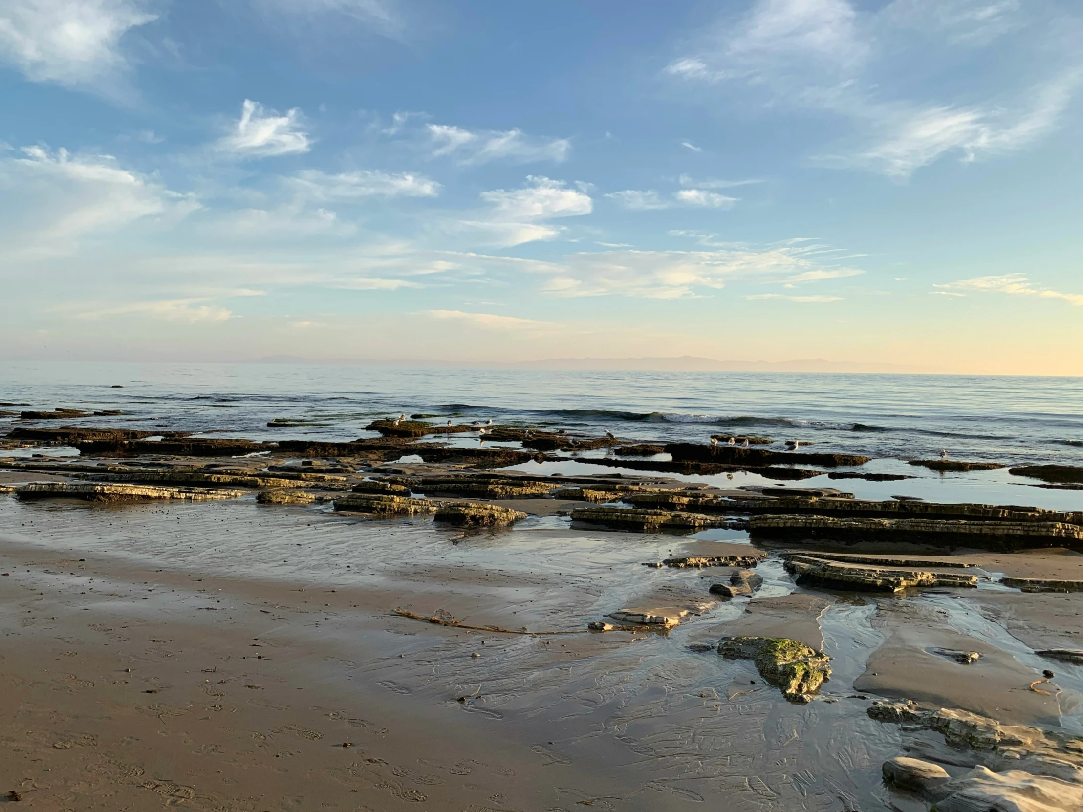 several large rocks that are on the water