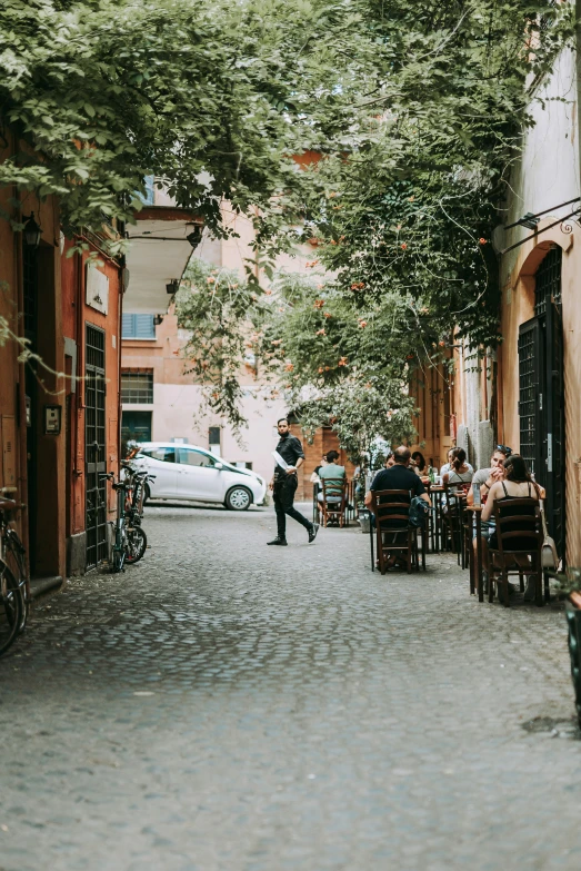 people are eating on the street outside the cafe