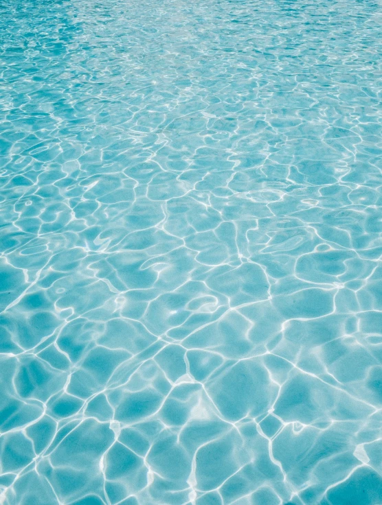 a small boat floating in the blue water