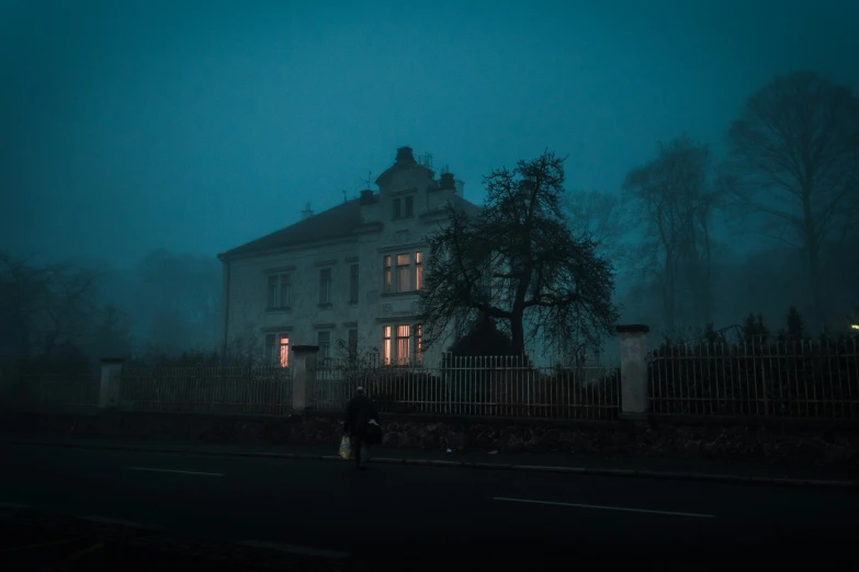 a house at night under an umbrella on a foggy day