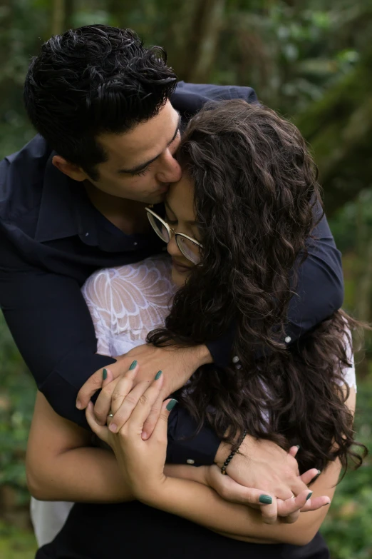 a young man and woman kissing each other