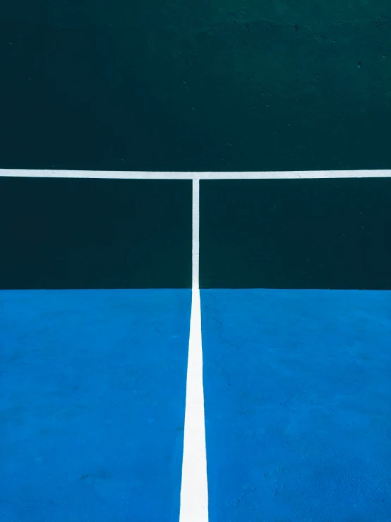 the tennis court is painted blue and black