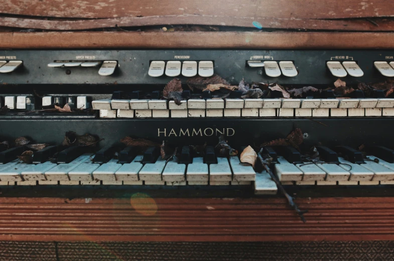 the front view of a large old, rusty pipe organ with keys labeled diamond