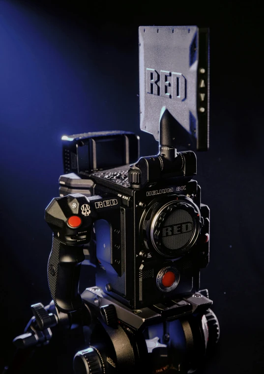 a camera with red light on, sits in the spotlight