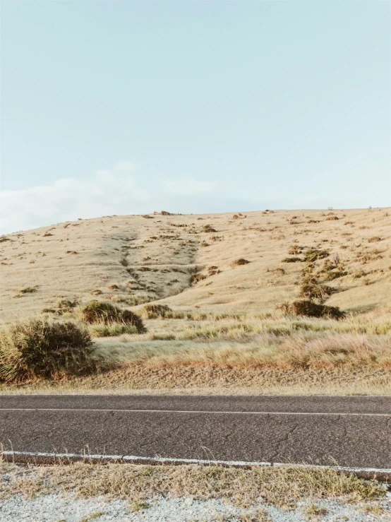 this is an asphalt road surrounded by sand hills