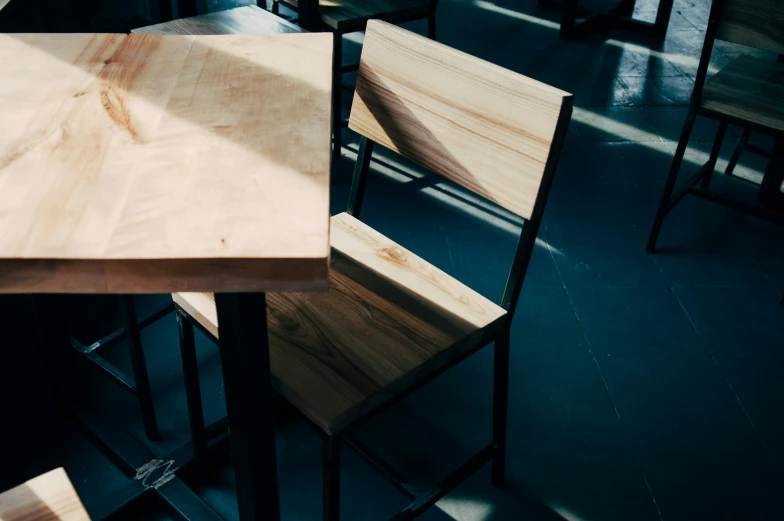 three wooden chairs sitting in a restaurant next to one another